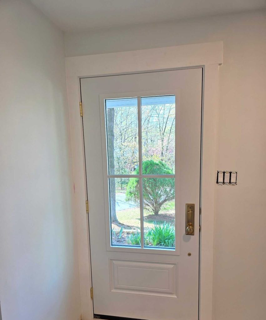 Interior side of the new ProVia Smooth Fiberglass entry door, white with brass hardware