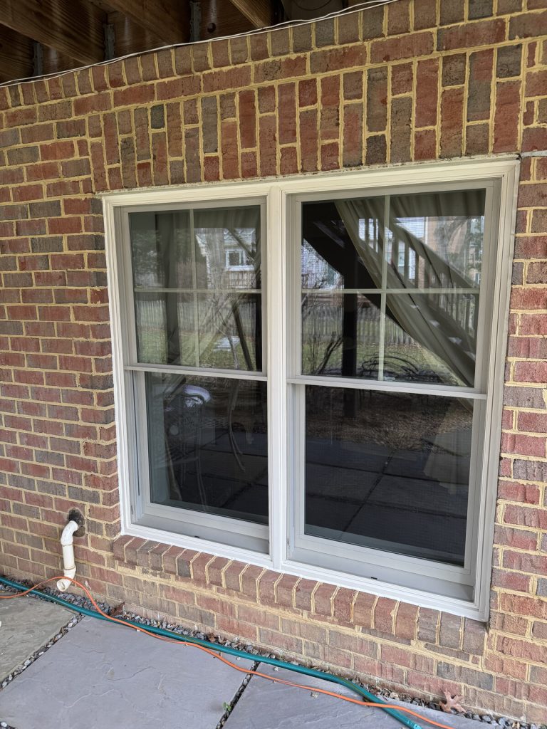 New tan double-hung replacement windows on a brick Northern Virginia home